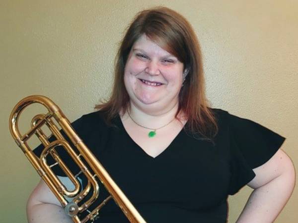 Woman holding brass instrument