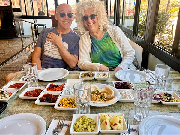 Older people sitting by salads