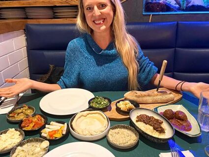 a woman sitting in front of food
