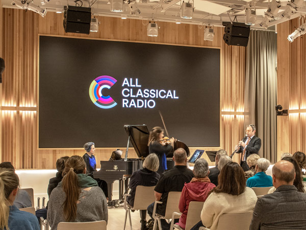 Audience in All Classical Radio Irving levin Performance Hall with musicians performing - wide angle