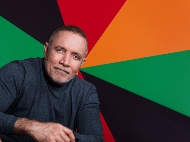 photo of Michael Abels against a black, red, orange, and green background