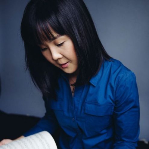 Photo of Jung Sun Kang looking at a score